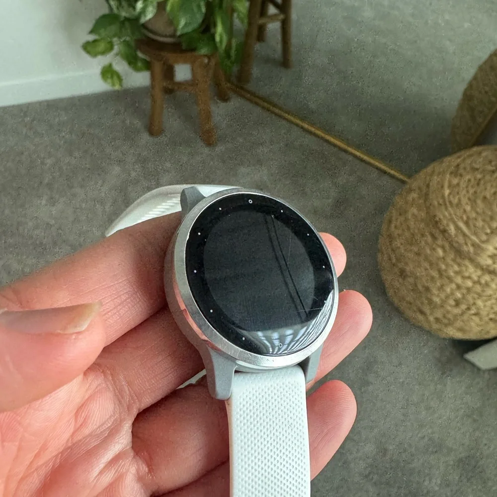garmin vivoactive 4s white smartwatch with black charger cable